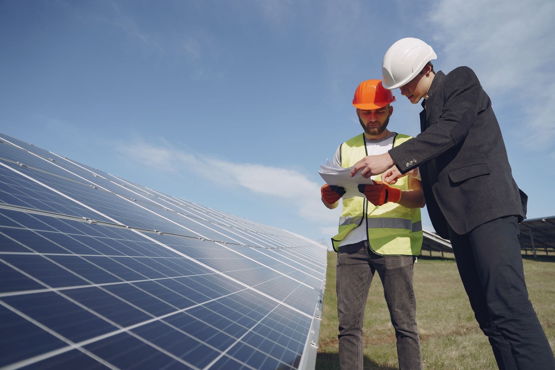 Solar technicians reviewing an installation on site